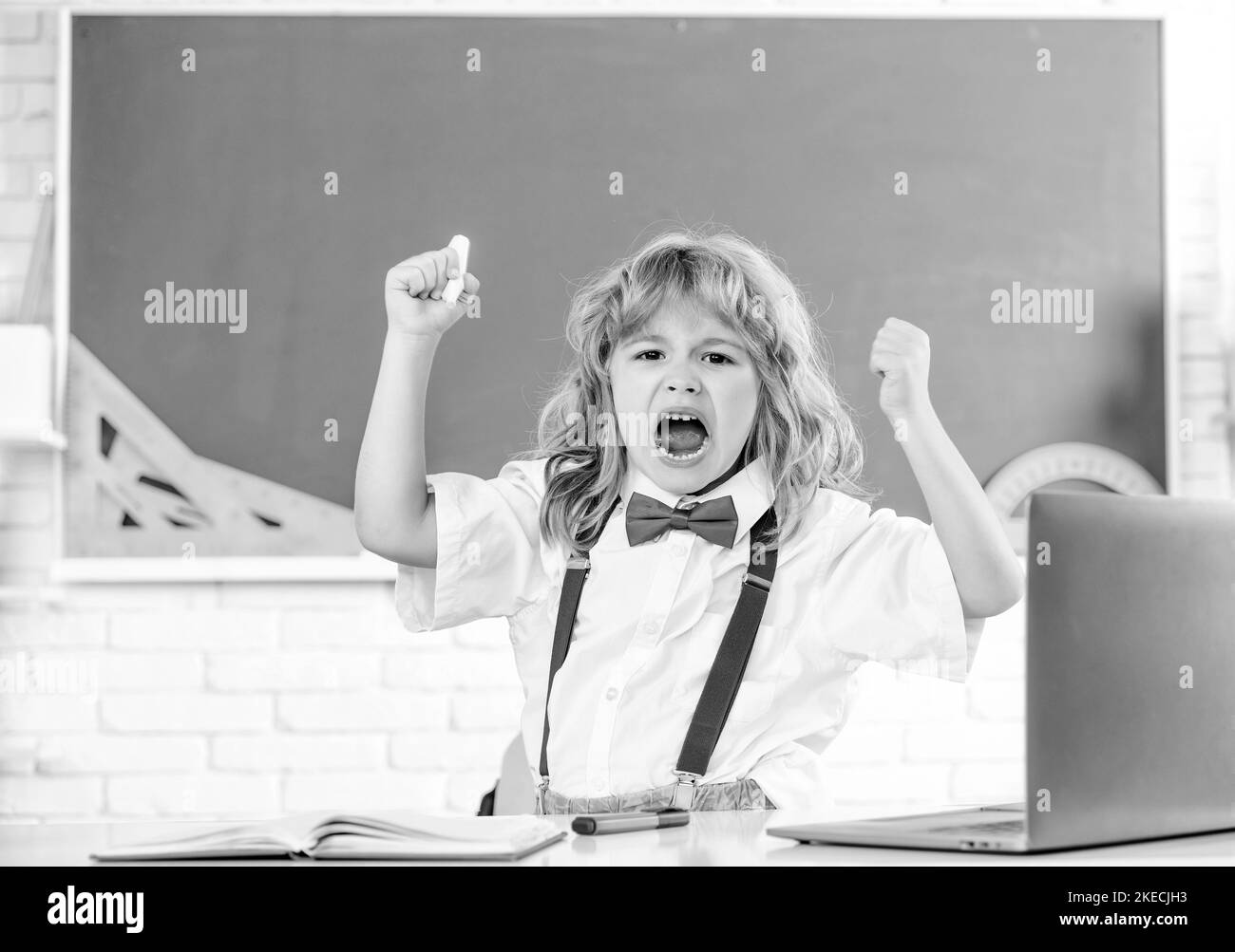concept of education. nerd kid with long hair at blackboard. september 1. Stock Photo