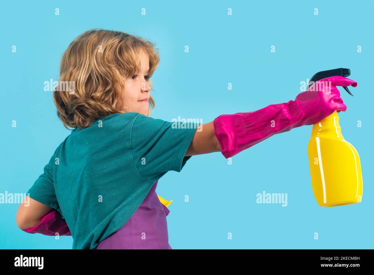 Child doing housework. Studio portrait of child use duster and gloves for cleaning. Funny child mopping house. Cleaning accessory, cleaning supplies Stock Photo