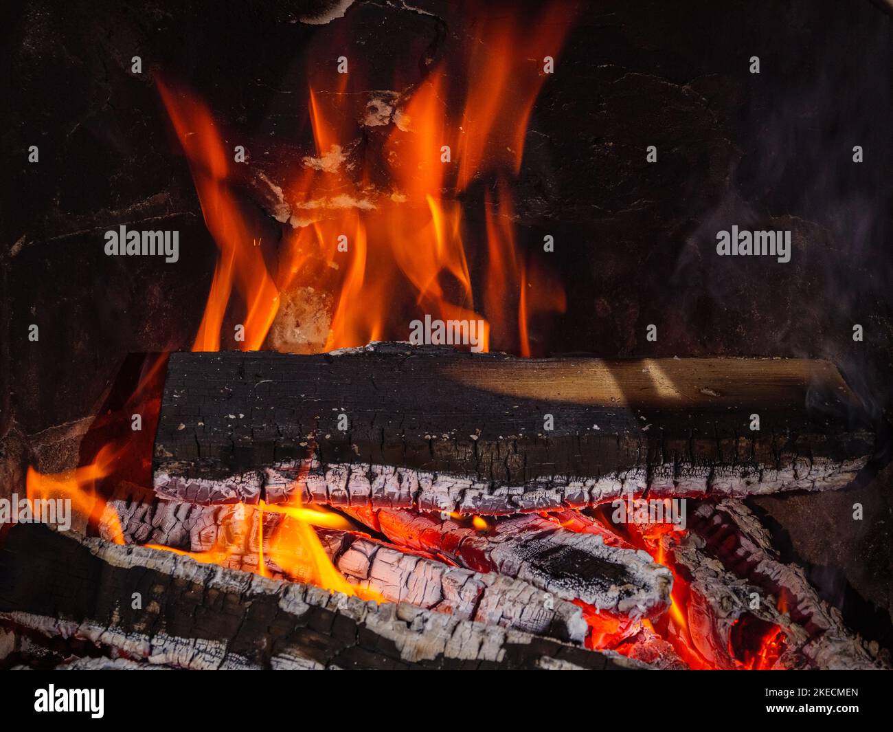 Cozy warm atmosphere from the fireplace with burning firewood Stock Photo