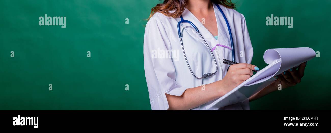 Doctor filling medical report for her patient.Doctor with stethoscope ...