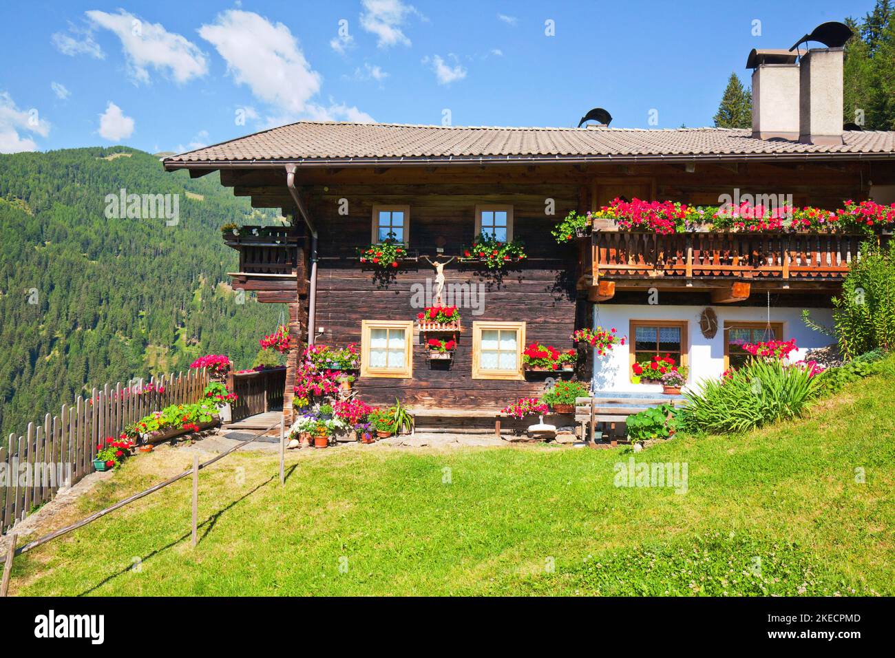 Old farmhouse with flower decoration in South Tyrolean Ulten Valley Stock Photo