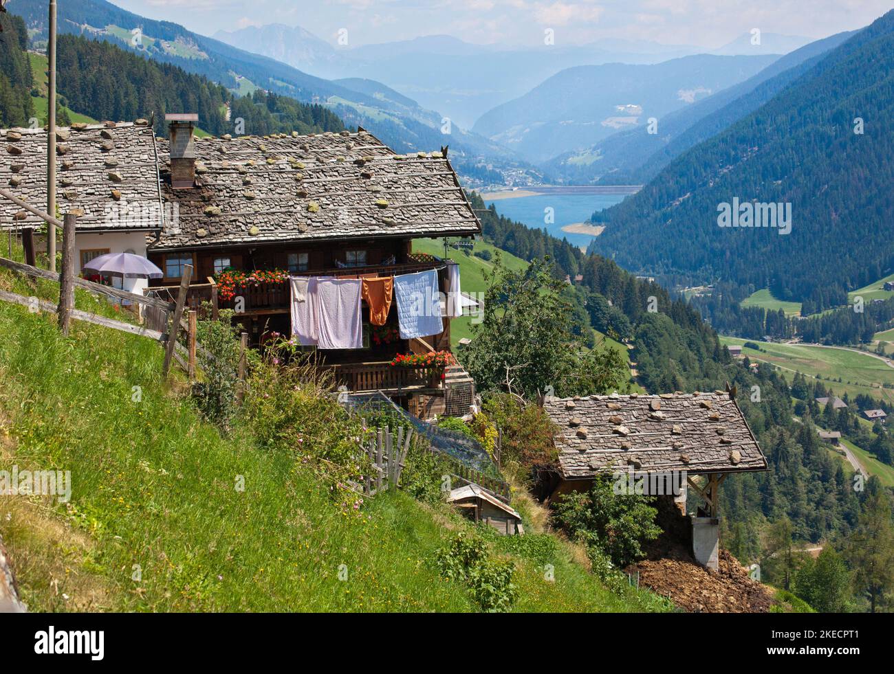 Mountain farms on the steep slope high above the valley floor in the South Tyrolean Ulten Valley Stock Photo