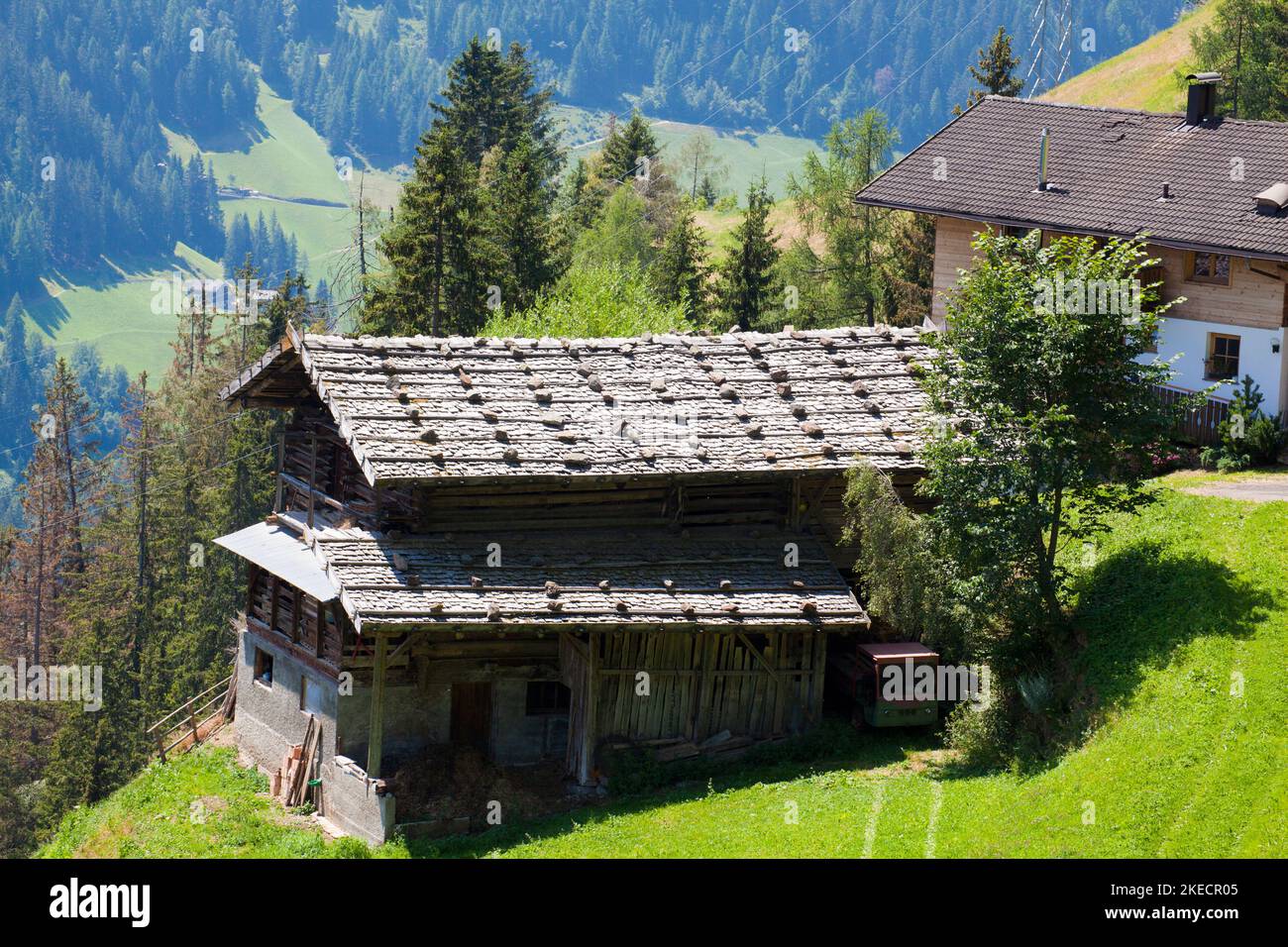 old barn in front of mountain farmhouse in South Tyrol Ulten Valley Stock Photo