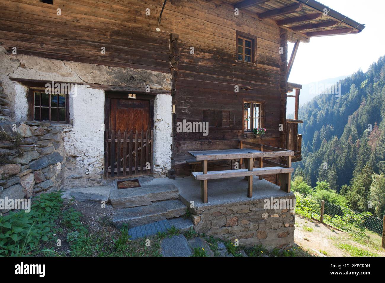 old mountain farmhouse on the steep slope in the South Tyrolean Ulten Valley Stock Photo