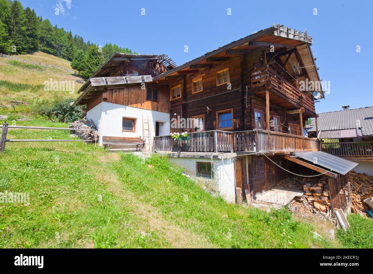 partly renovated mountain farm with solar panel, built on a steep slope in the South Tyrolean Ulten Valley Stock Photo