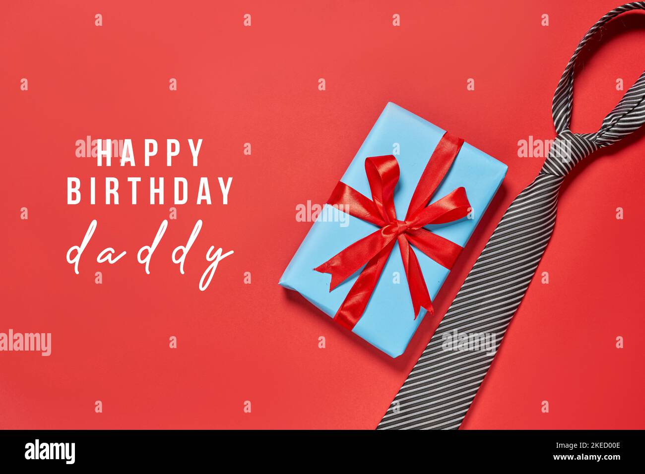 A birthday tag with a red ribbon and bow. The text 'Happy Birthday' on the  top Stock Photo - Alamy