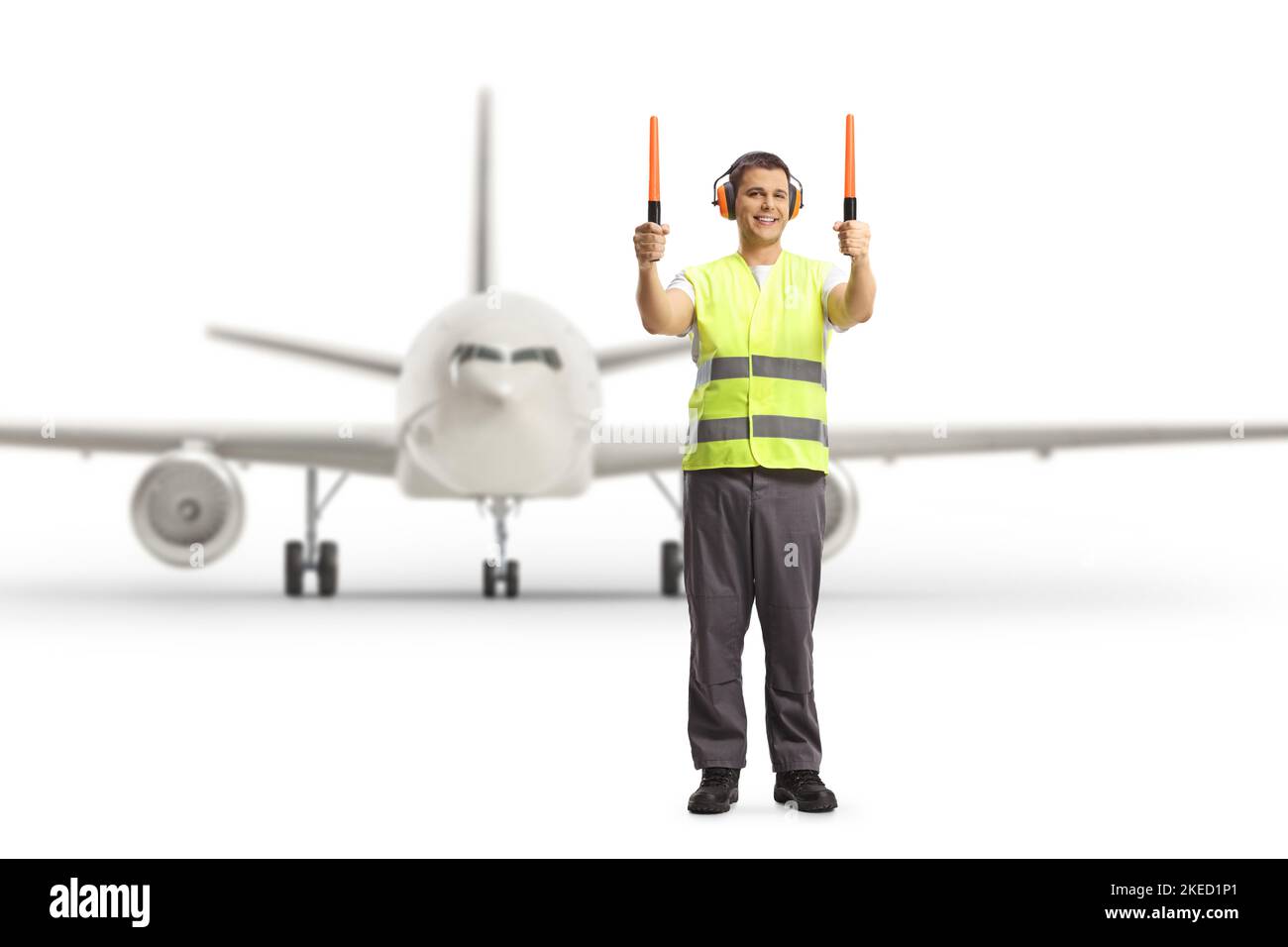 Aircraft marshaller signaling with wands in front of an aircraft at an