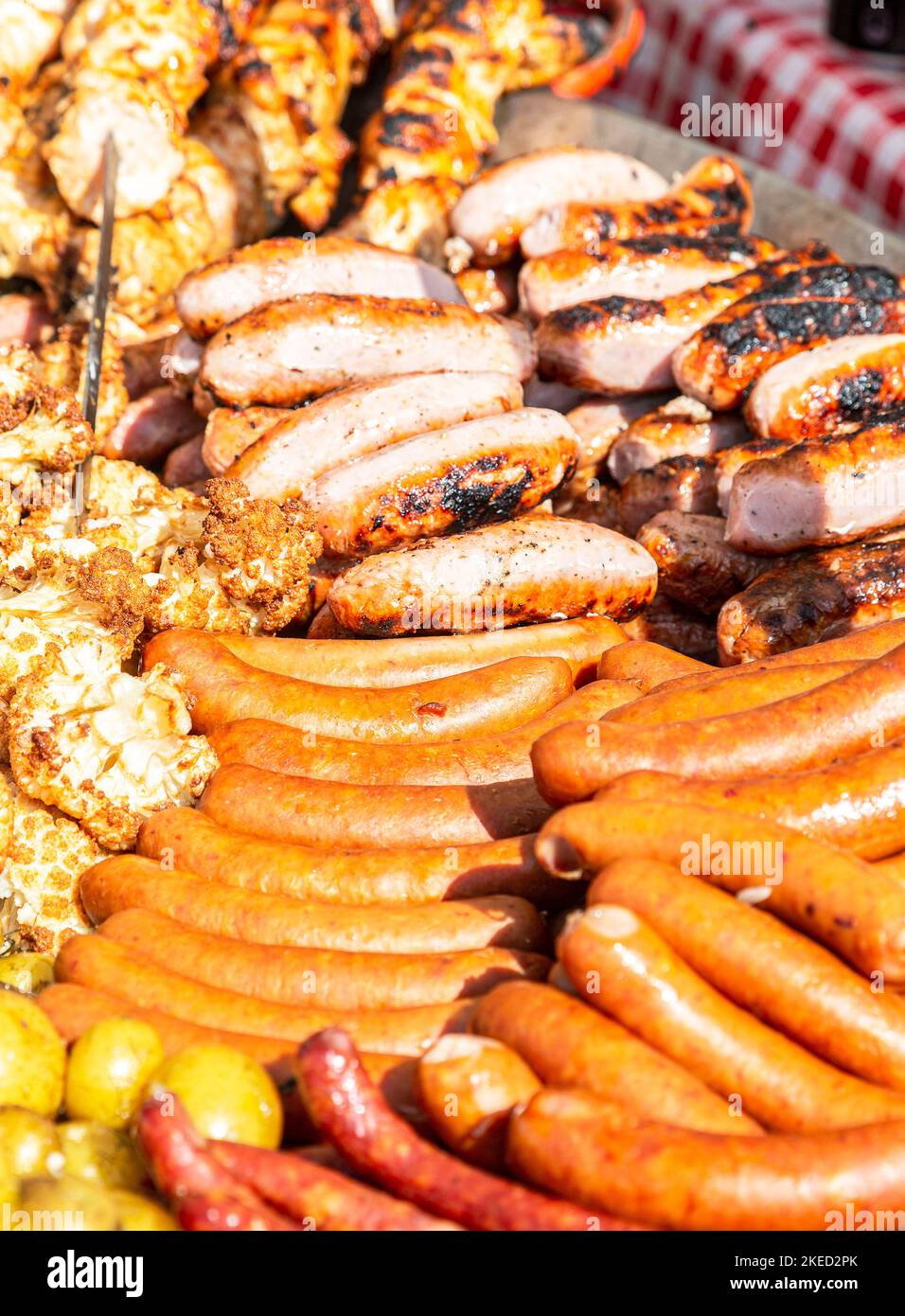 Delicious sausages from meat grilling over hot coals for a picnic lunch Stock Photo