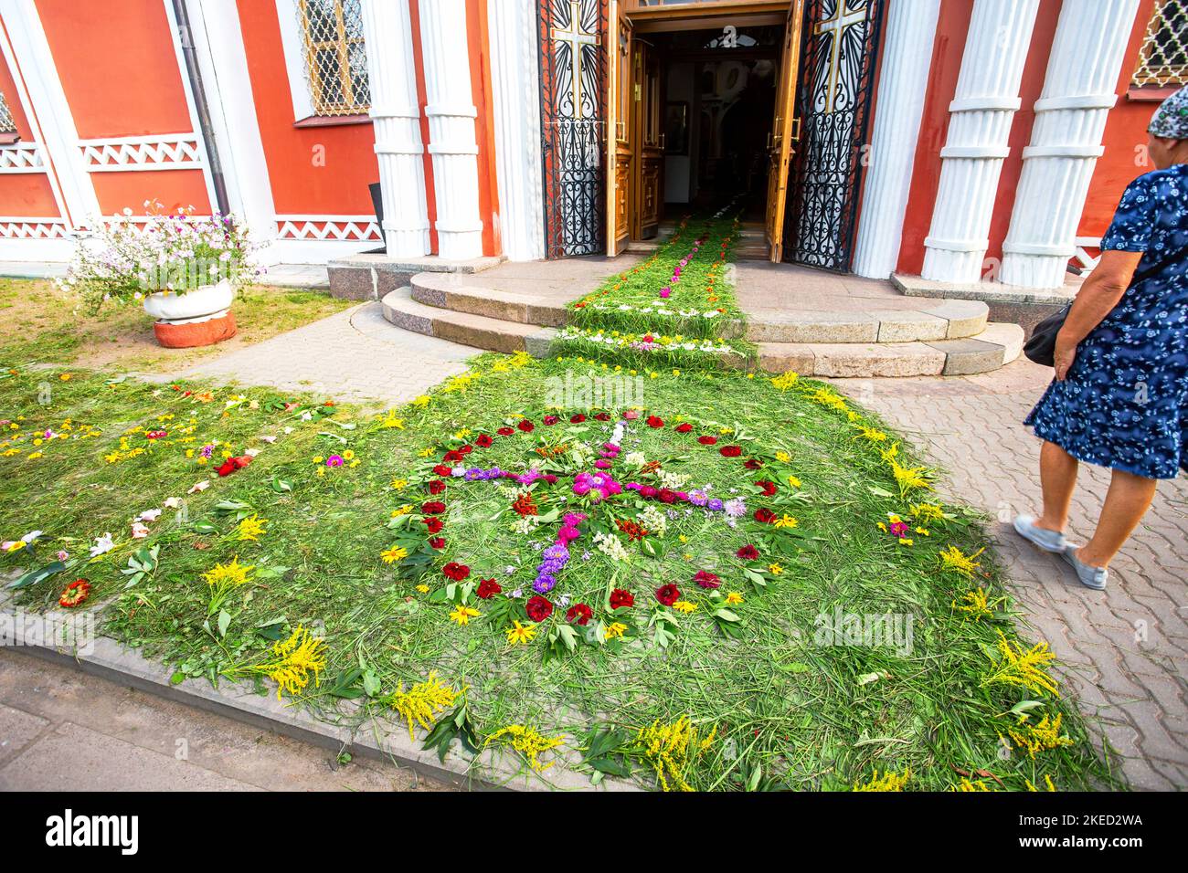 Entrance to an Orthodox church strewn with flowers and grass. Cathedral of the Resurrection of Christ in Staraya Russa, Russia Stock Photo
