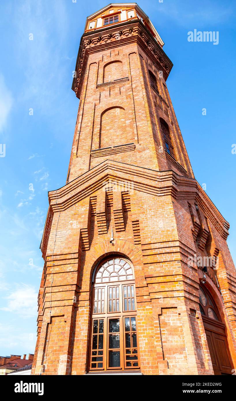 Old brick water tower against the blue sky in Staraya Russa, Russia Stock Photo