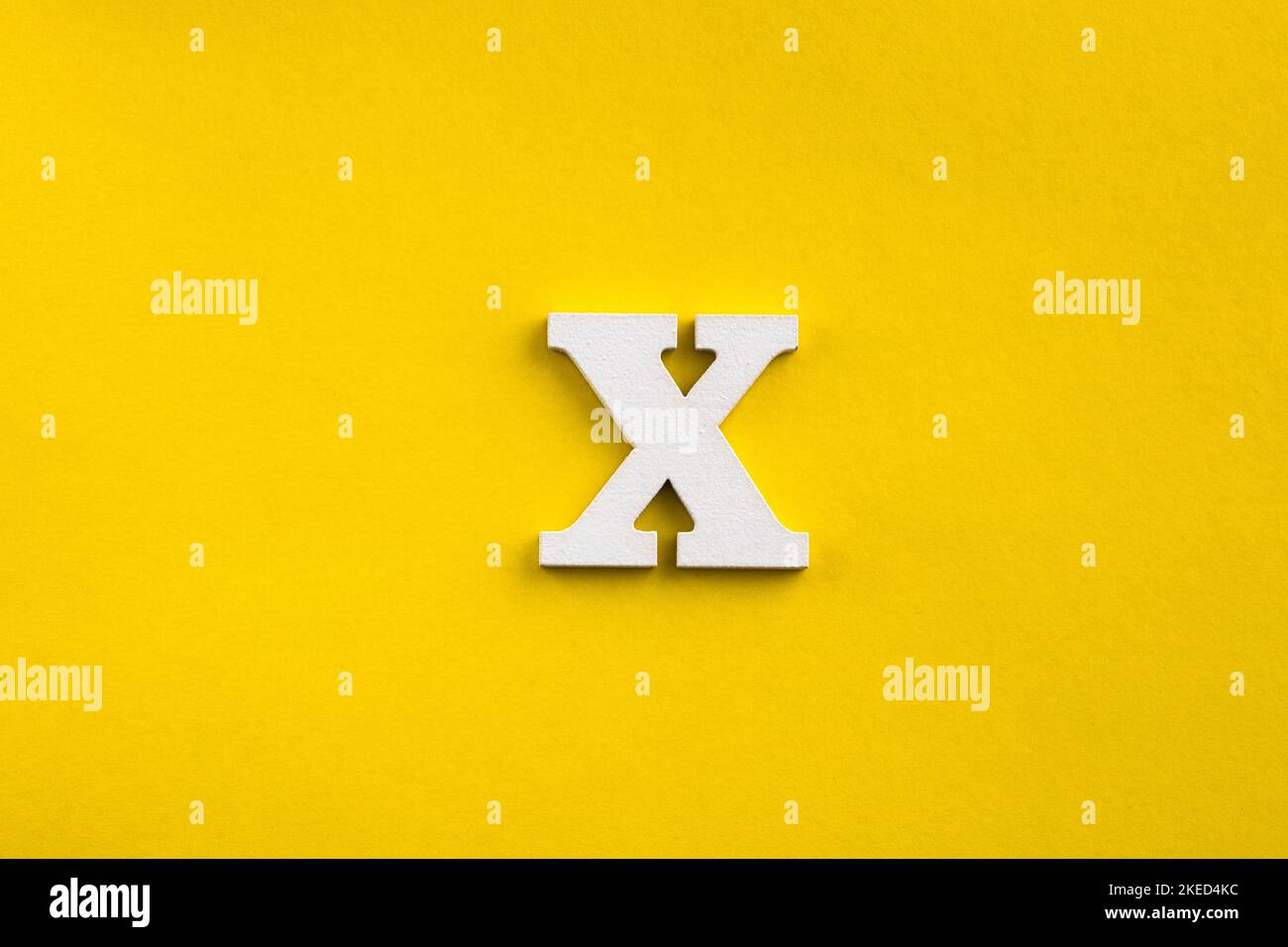 letter X uppercase - white wood letter on yellow color background Stock ...