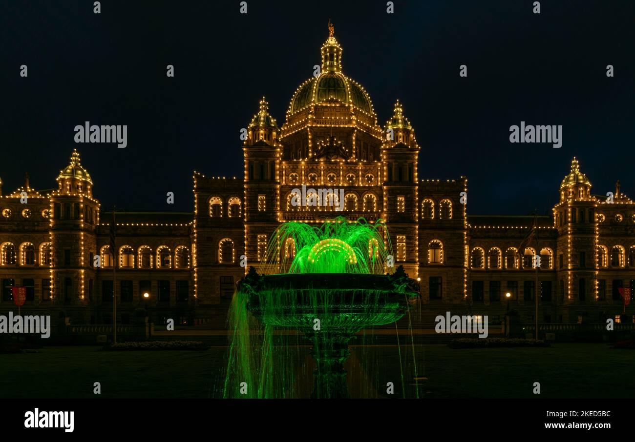 The British Columbia Parliament Buildings and a fountain illuminated at night in Victoria, Canada. Stock Photo