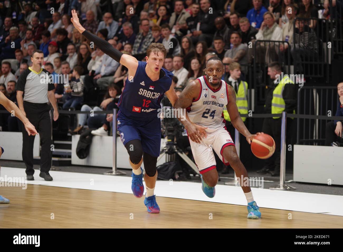 Newcastle upon Tyne, England, 11 November 2022. Aleksa Radanov playing for Serbia and Carl Wheatle playing for Great Britain in the FIBA Basketball World Cup 2023 Qualifiers at the Vertu Motors Arena. Credit: Colin Edwards/Alamy Live News Stock Photo