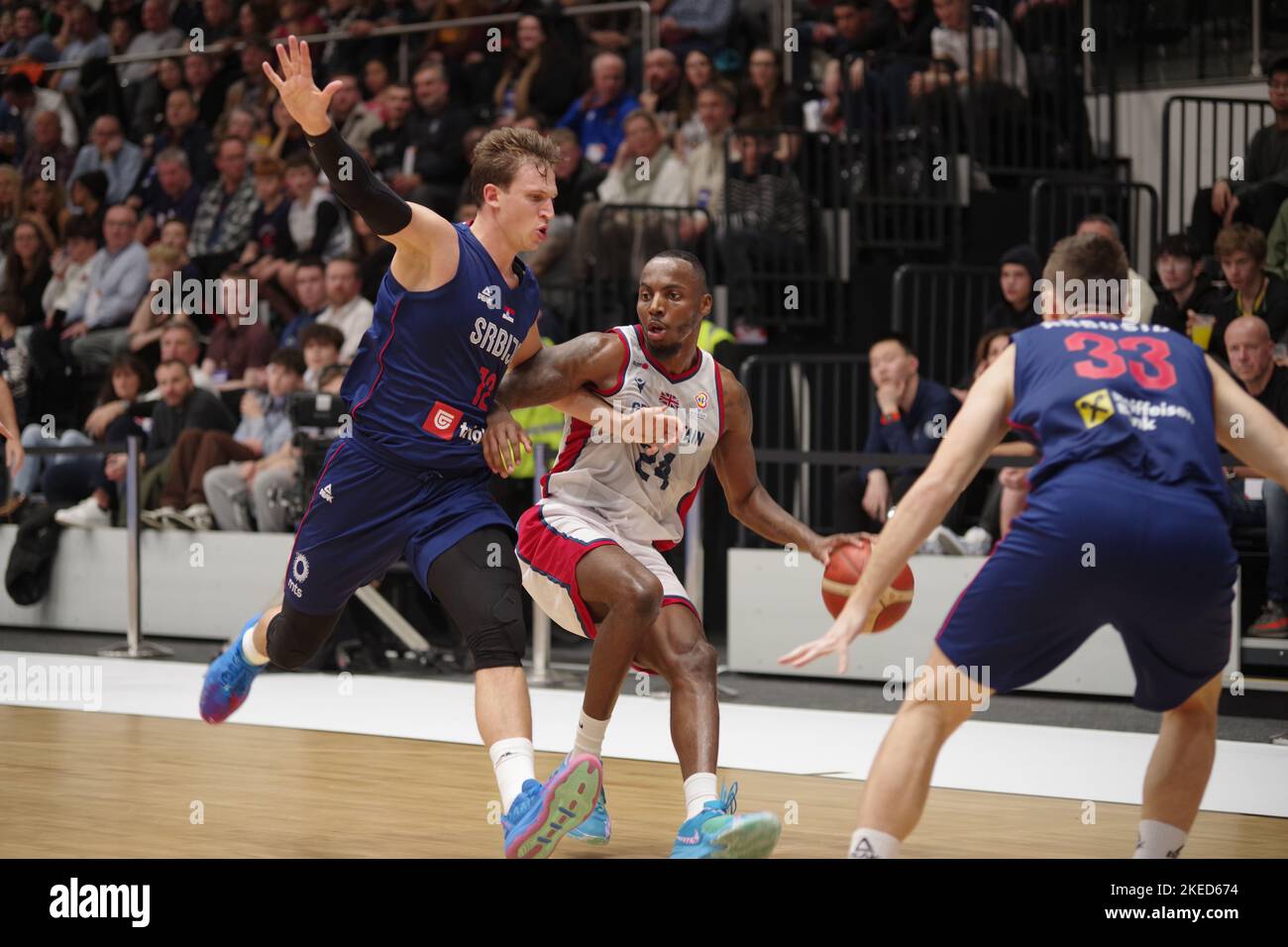 Newcastle upon Tyne, England, 11 November 2022. Aleksa Radanov playing for Serbia and Carl Wheatle playing for Great Britain in the FIBA Basketball World Cup 2023 Qualifiers at the Vertu Motors Arena. Credit: Colin Edwards/Alamy Live News Stock Photo