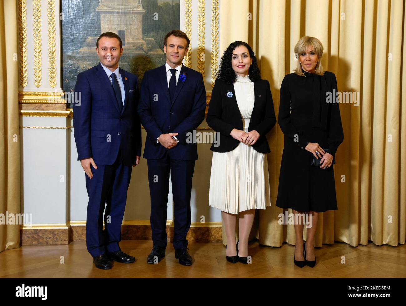 French President Emmanuel Macron poses alongside his wife Brigitte Macron  and Kosovo's President Vjosa Osmani and her husband Prindon Sadriu as they  attend a dinner of the Paris Peace Forum at the