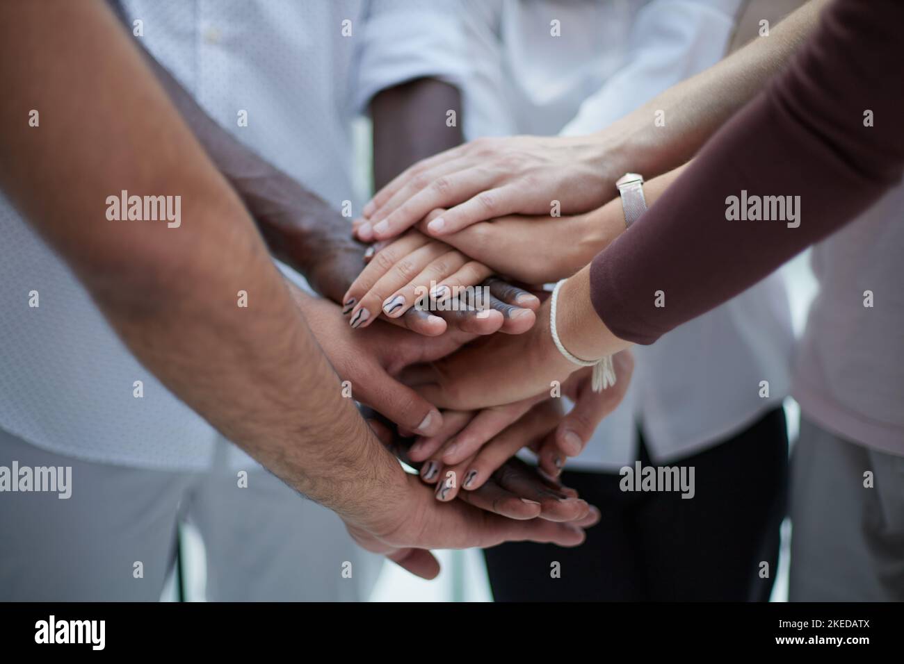 Business people joining hands in the office. concept of teamwork and ...