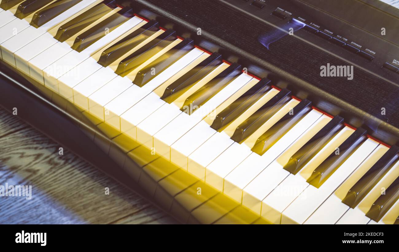 Fragment of a musical instrument. White and black piano keys. Close-up ...