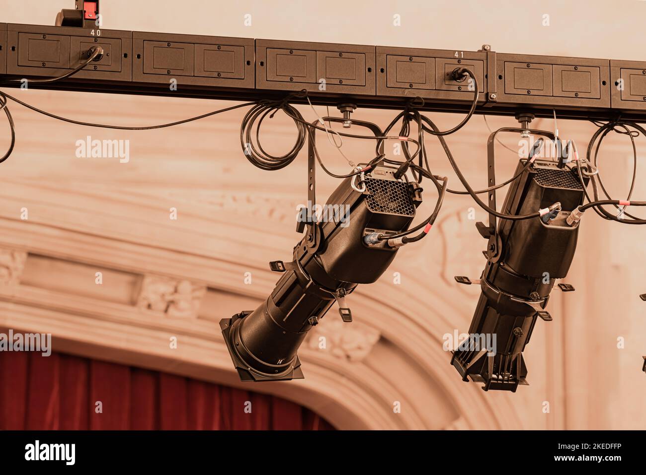 Closeup photo of two new large theater spot lights hung within an older theatre or auditorium. Stock Photo