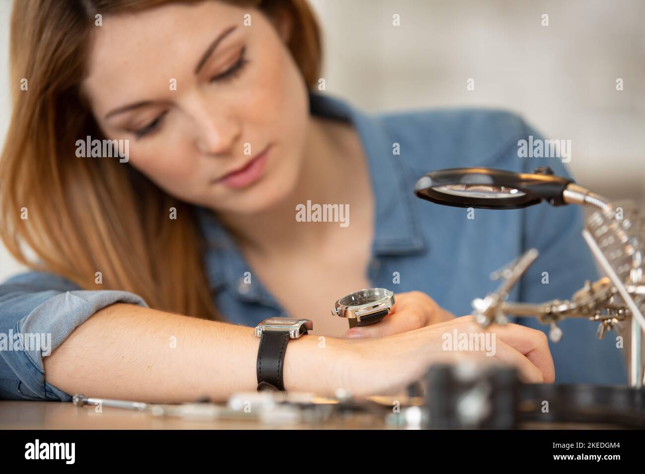 happy woman repairing a clocks Stock Photo