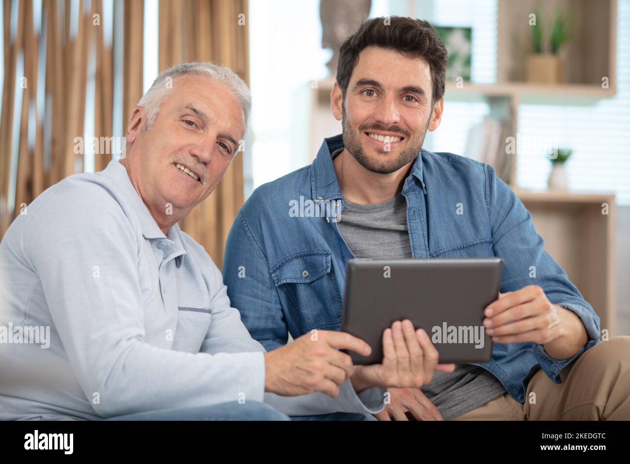 senior father and young son with tablet Stock Photo