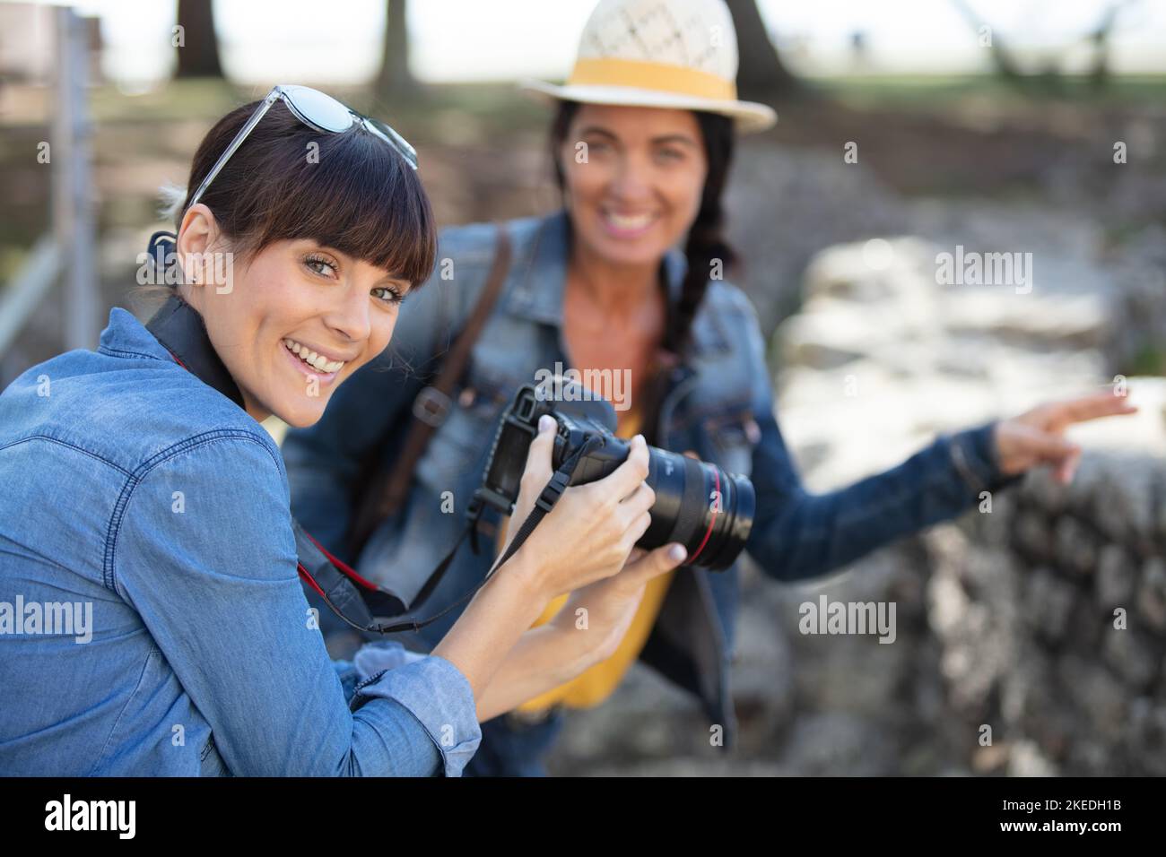 cheerful female friends taking photos Stock Photo