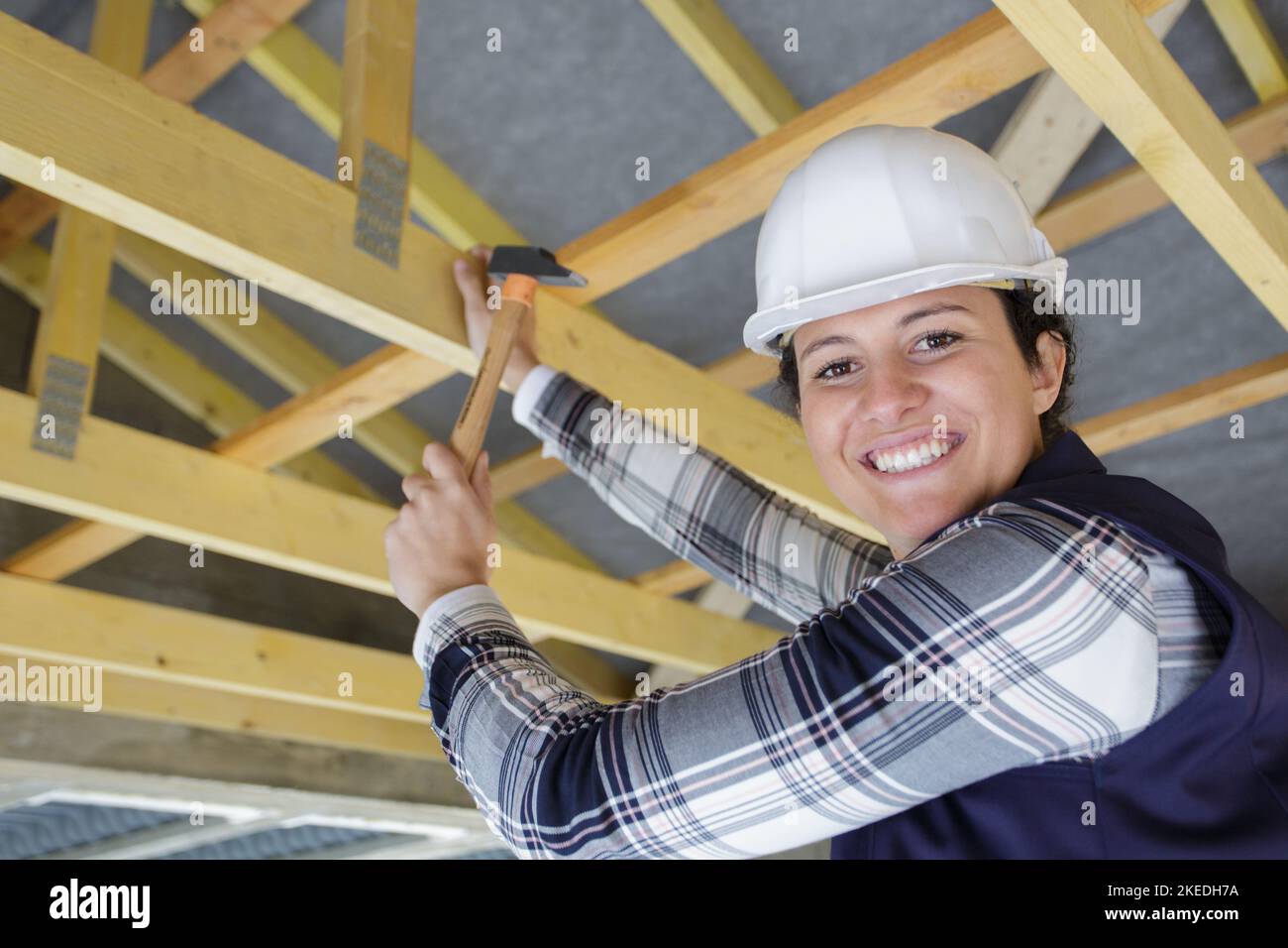 female carpenter working on wooden roof joist Stock Photo Alamy