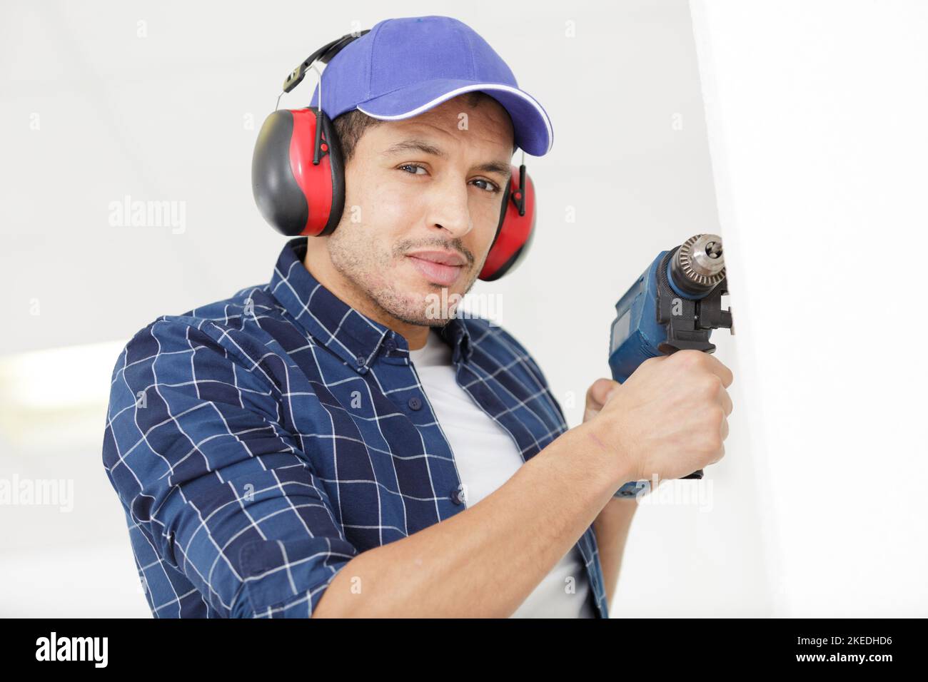 workman using noisy power drill on a wall Stock Photo Alamy
