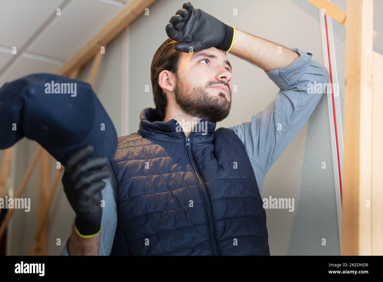 young builder is tired of working Stock Photo