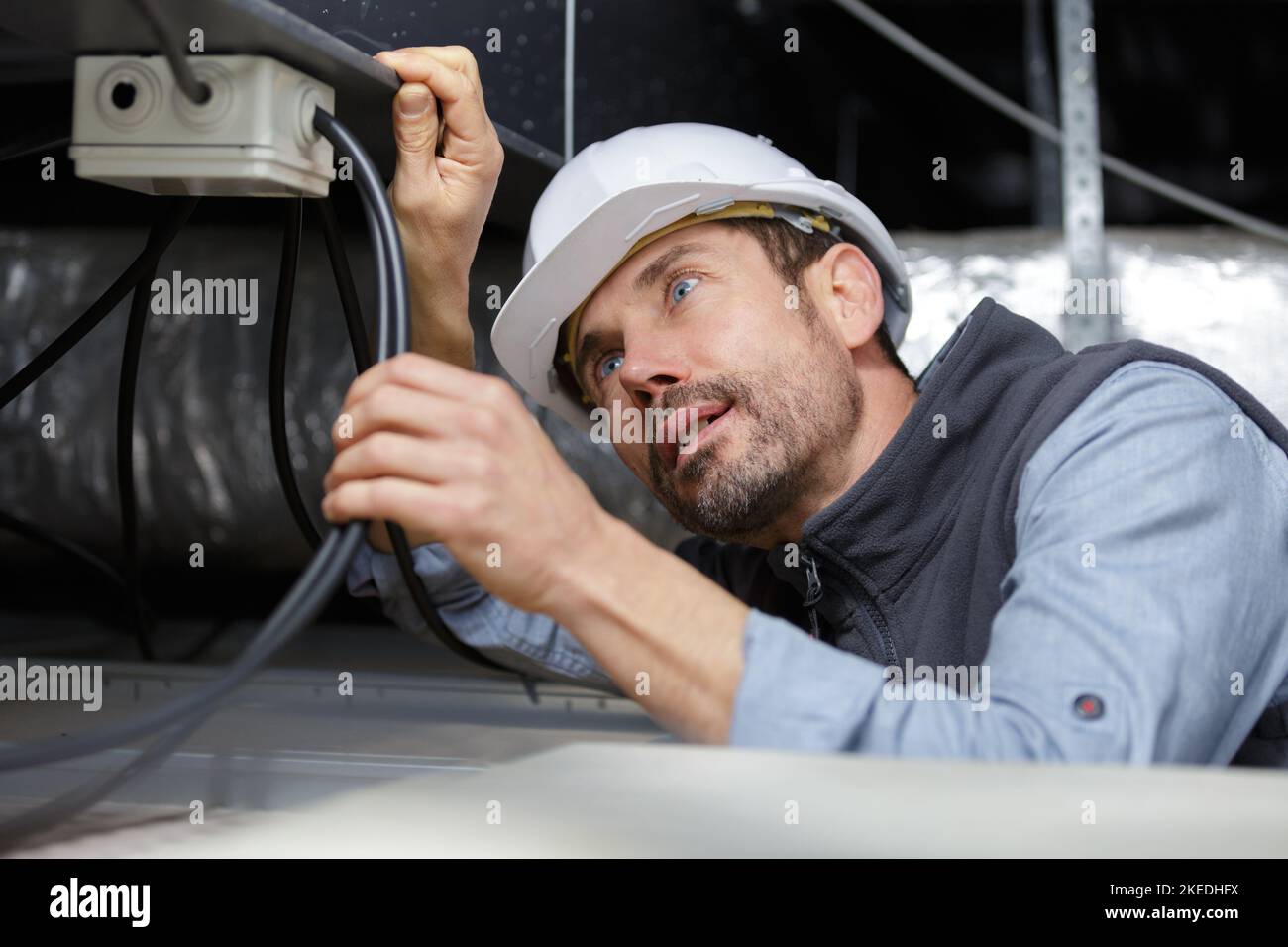 electrician fixing neon on the ceiling Stock Photo - Alamy