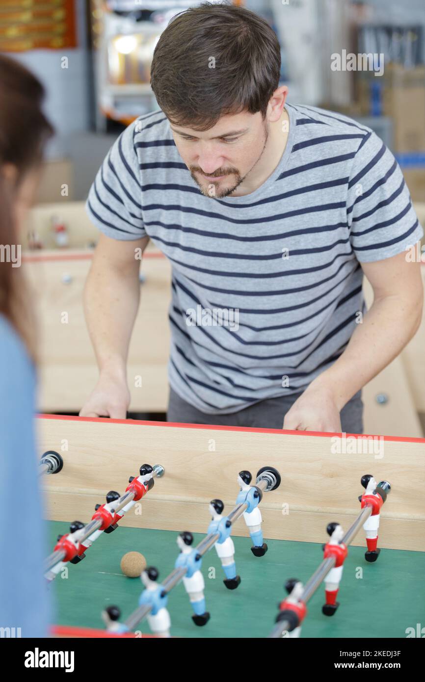 man playing football table game Stock Photo Alamy
