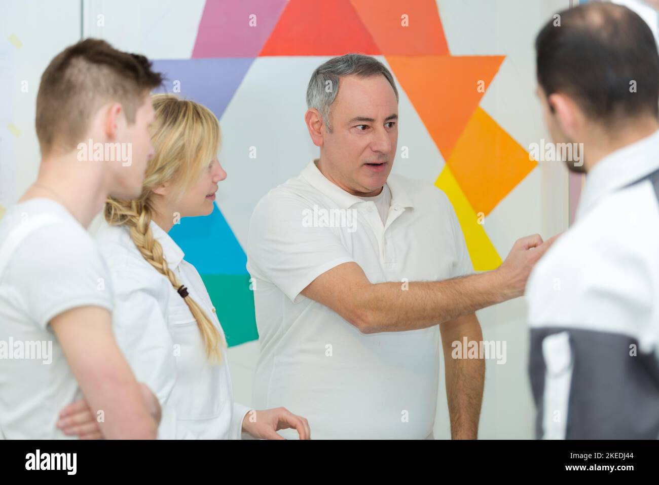 portrait of painter teaching apprentices Stock Photo