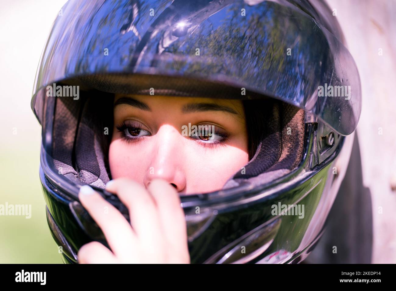 Close Up on the Eyes of Teenage Female Adjusting Dirt Bike Helmet ...