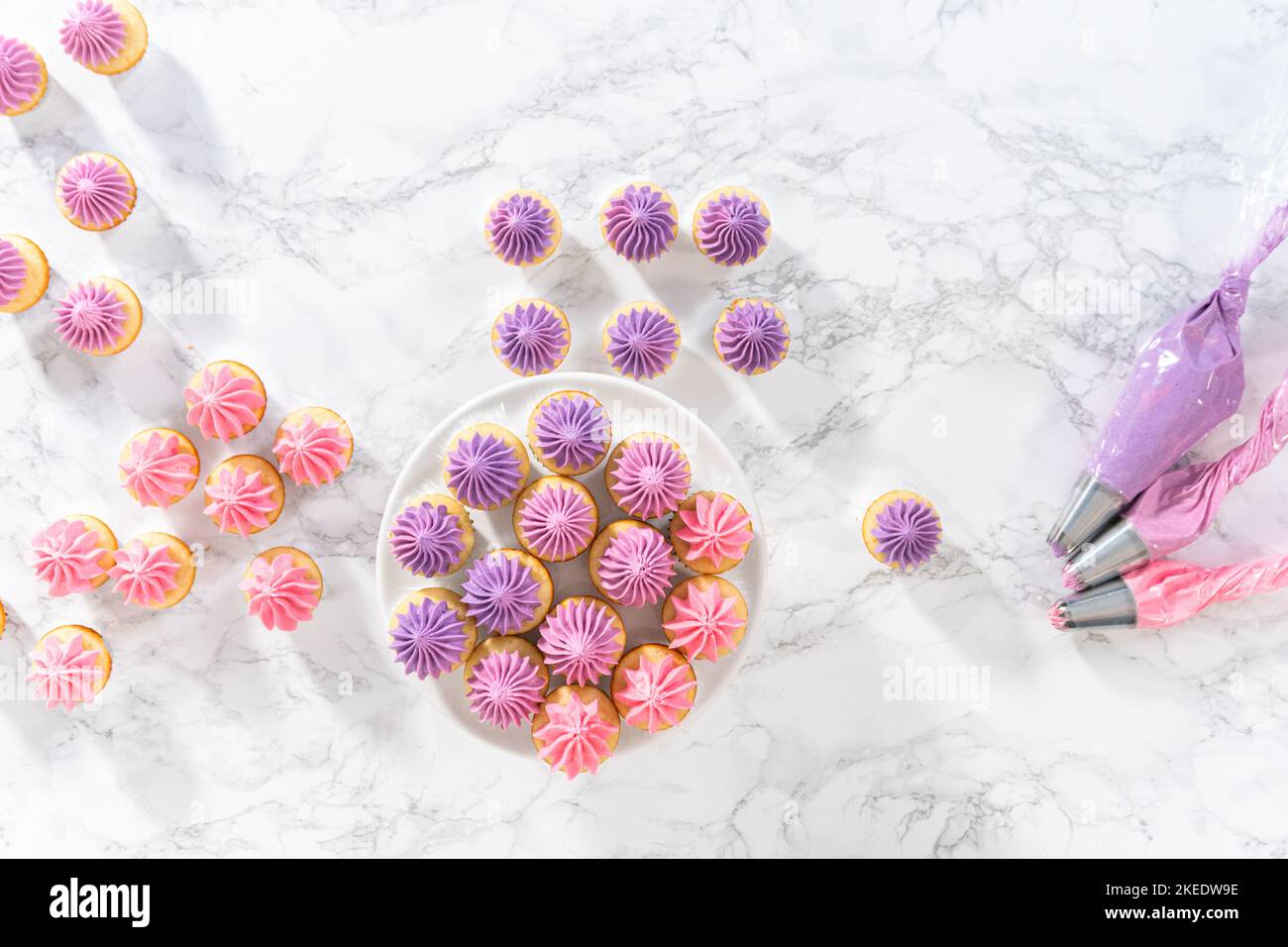 Mini Vanilla Cupcakes with Pink Buttercream Frosting Stock Photo - Alamy