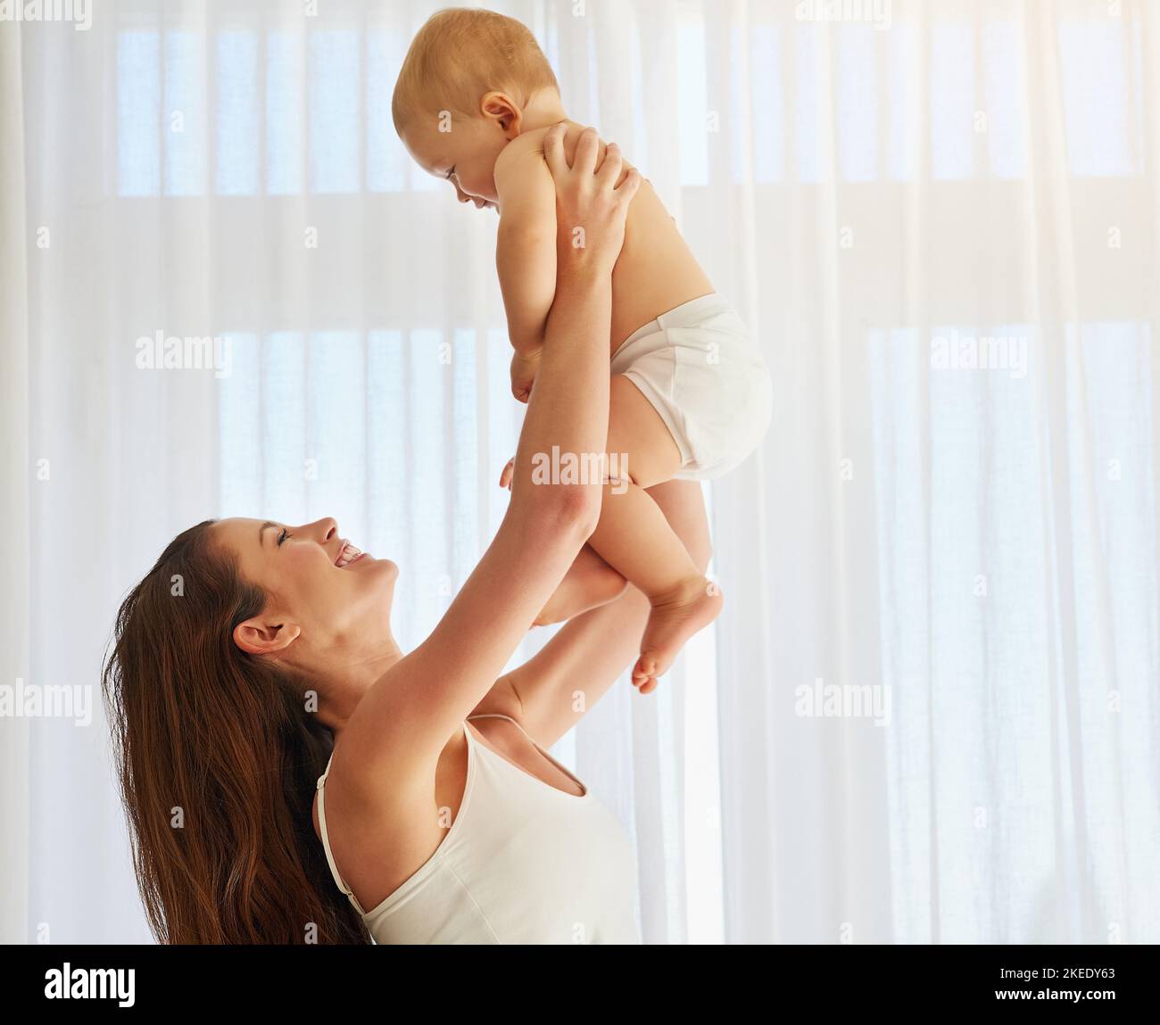 Theyre in high spirits. a mother spending quality time with her baby boy at home. Stock Photo