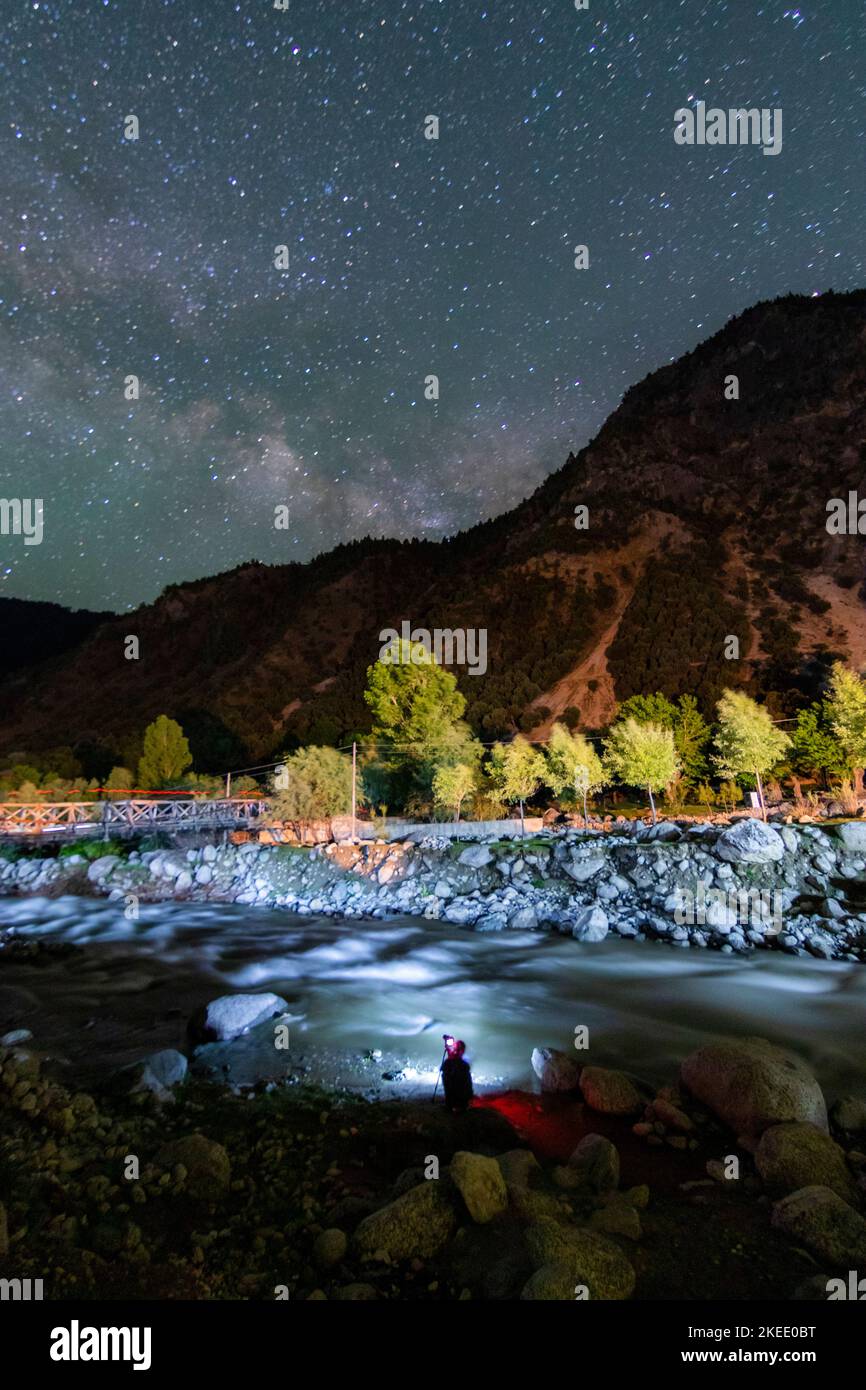 night landscape with water in the river and stars on the sky ...