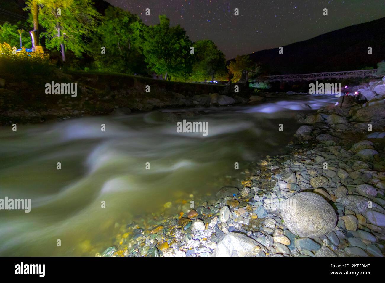 night landscape with water in the river and stars on the sky ...