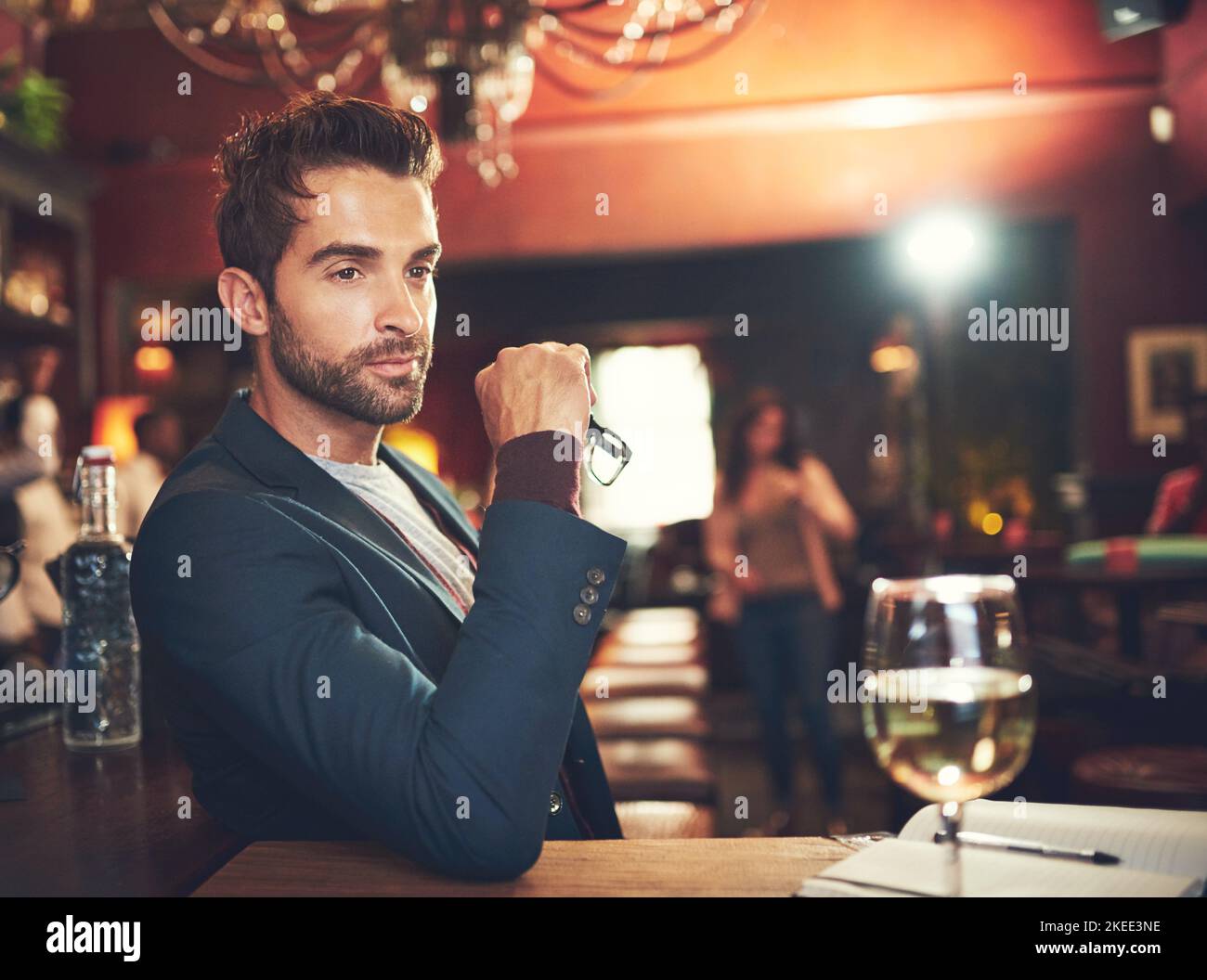 He comes here to think. a young man sitting in a bar. Stock Photo