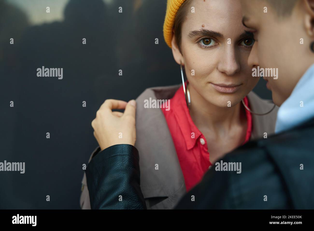 Two women stand against the background of a stone wall Stock Photo Alamy