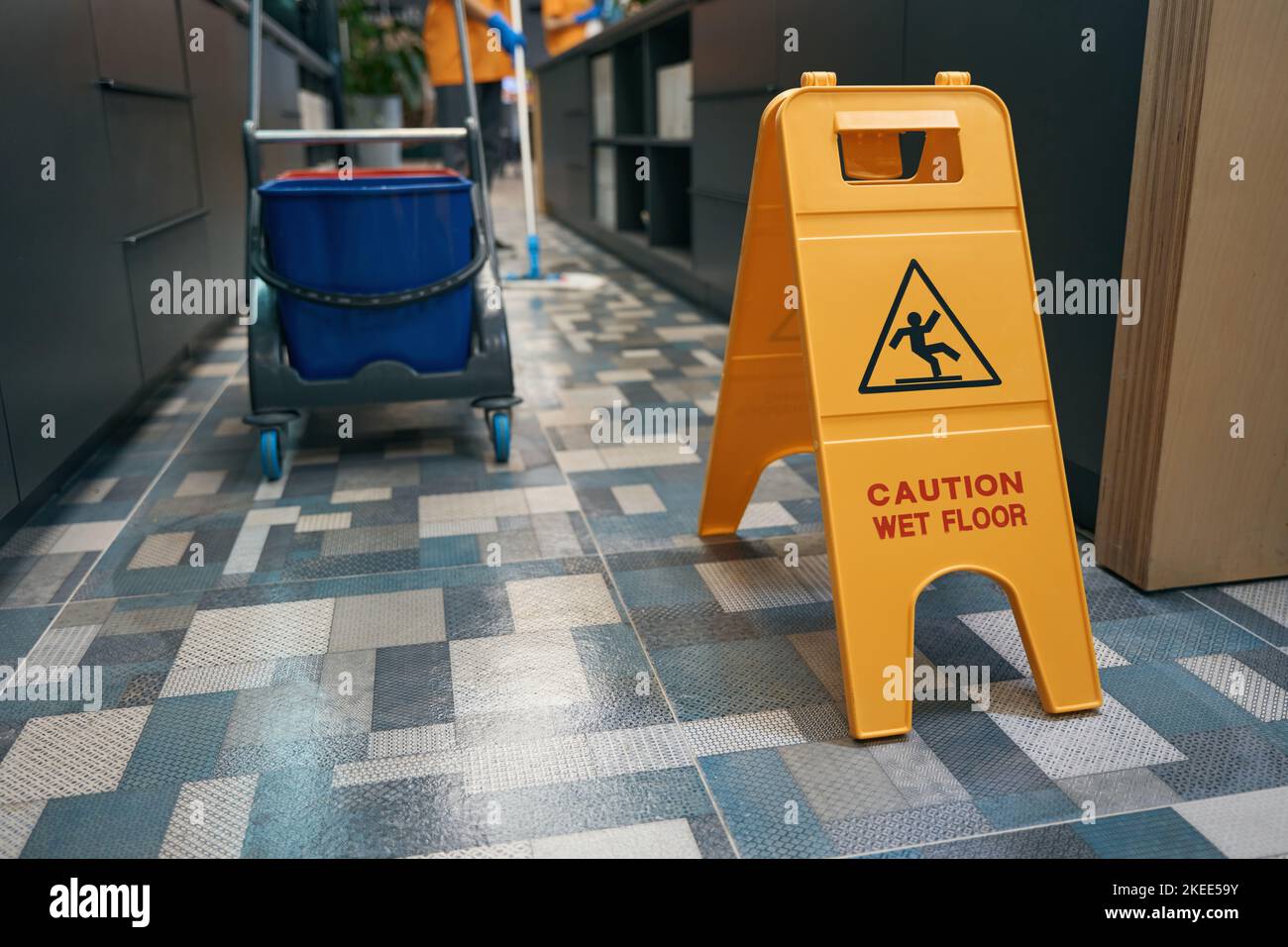 Warning sign Caution wet floor stands in office on floor Stock Photo