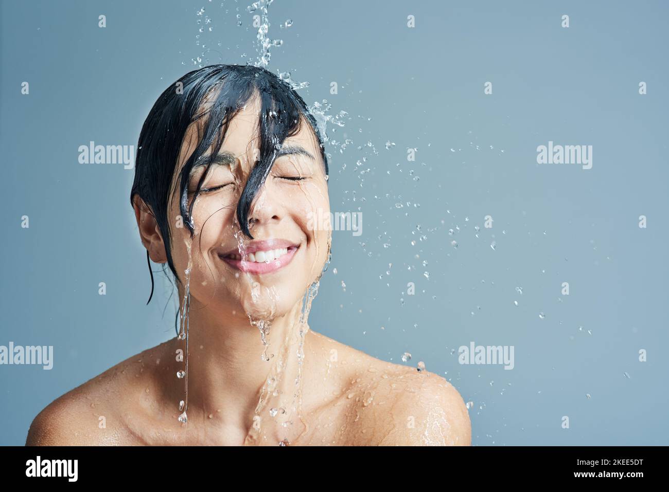 Awakening her senses with a refreshing shower. a young woman having a