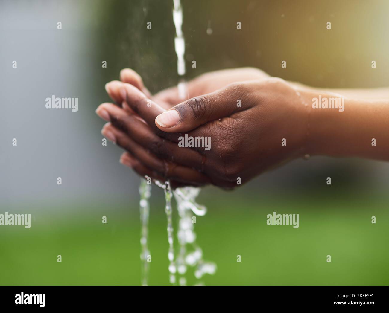 The worth of water is priceless. a woman washing her hands outdoors. Stock Photo