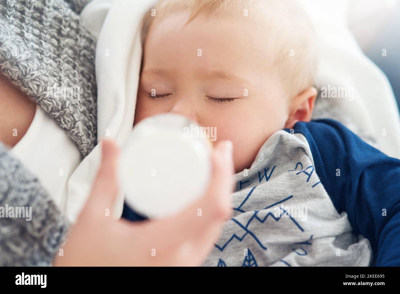 Nutrition and naps make for a healthy growing baby. a mother feeding her baby boy at home. Stock Photo