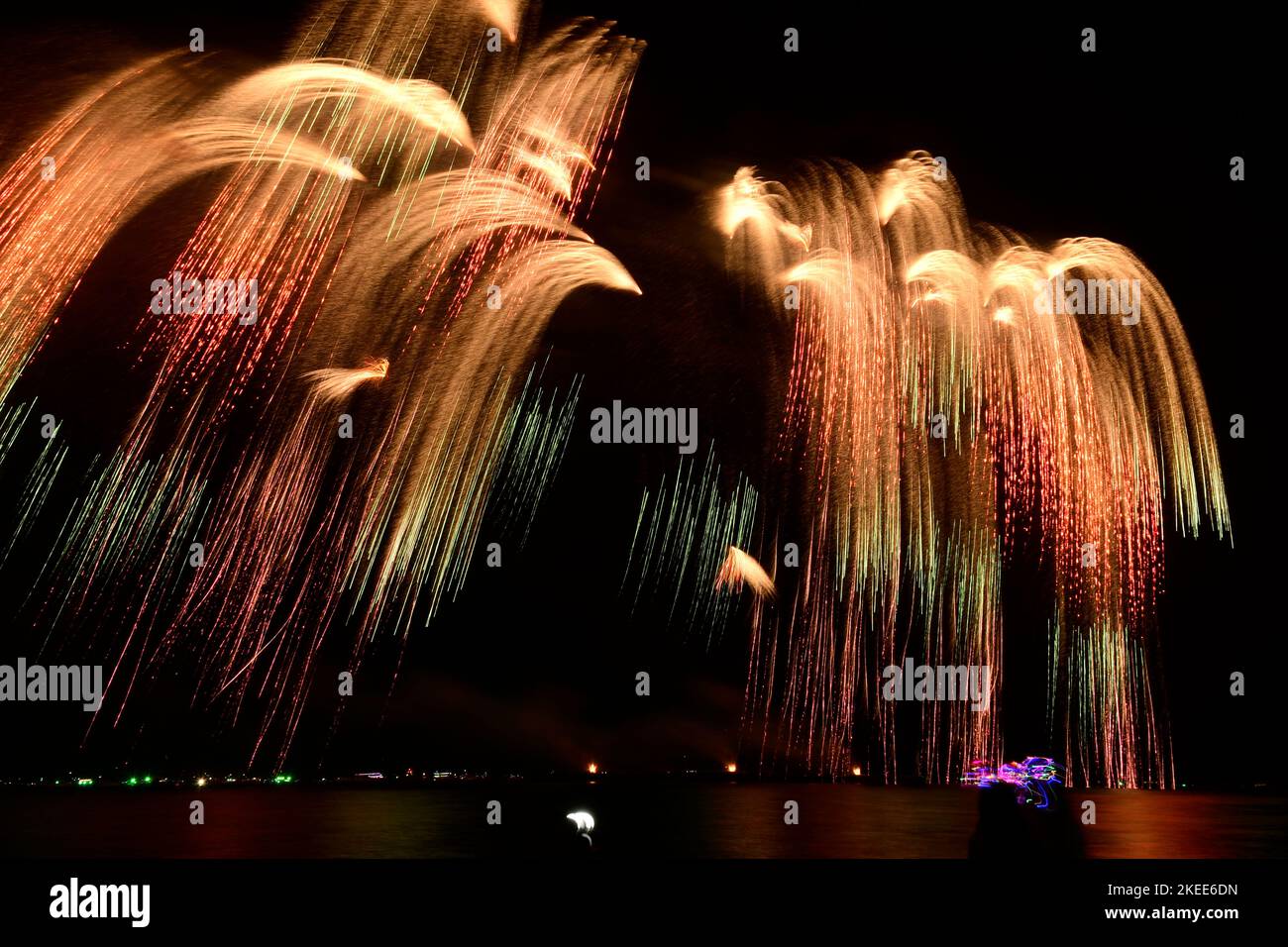 Firework celebration from the sea shore. Colorful fireworks celebration