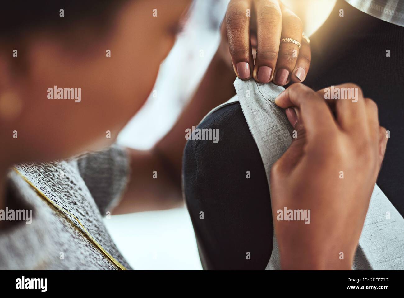 Every stitch is important. a young fashion designer working on a mannequin in her workshop. Stock Photo