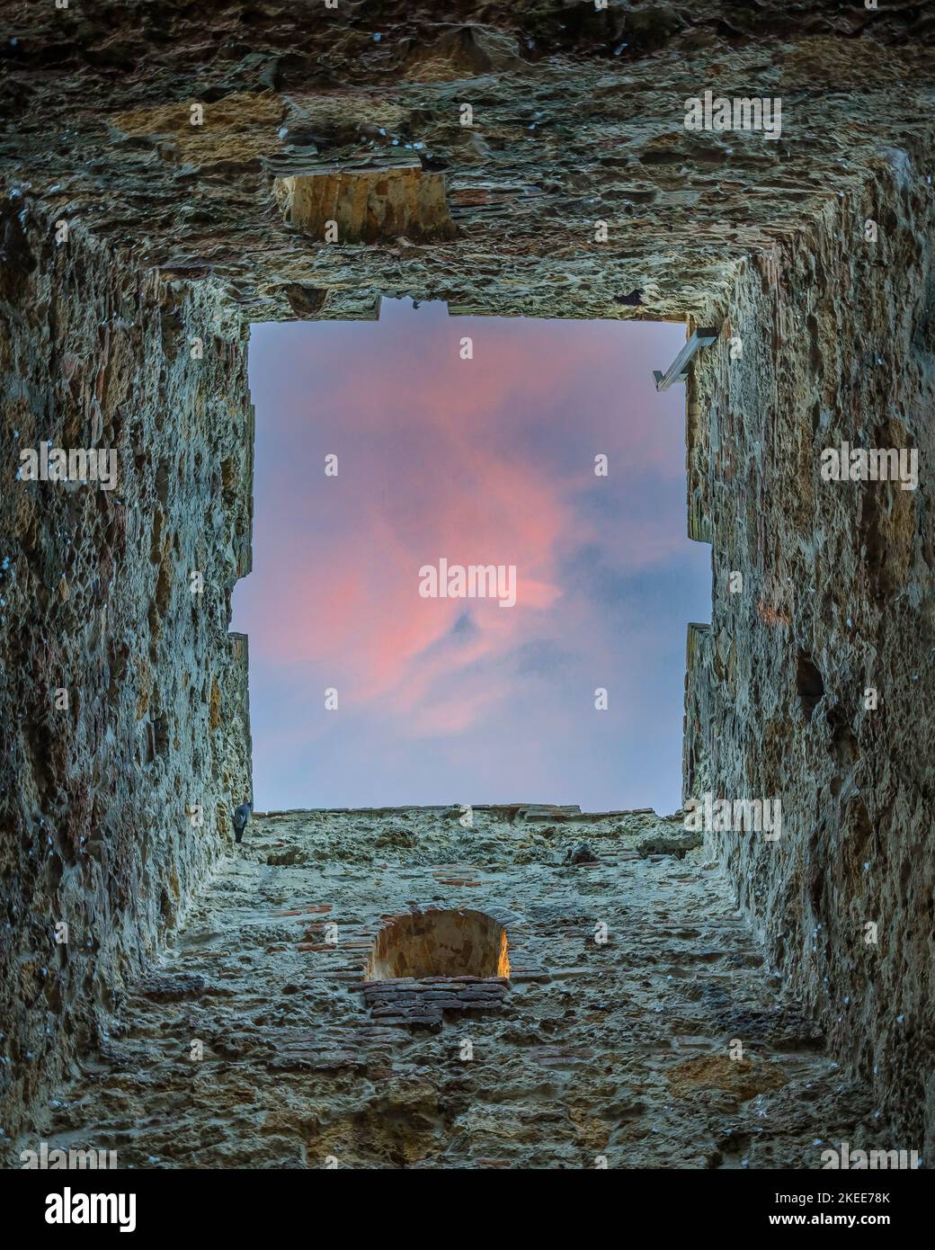 A low angle shot inside a deep rock stone under purple sunset sky Stock ...
