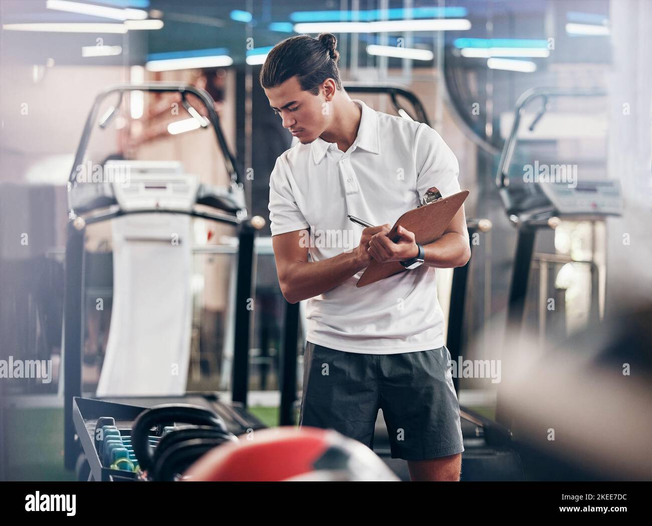 Gym, coach and clipboard with a man manager checking equipment in the