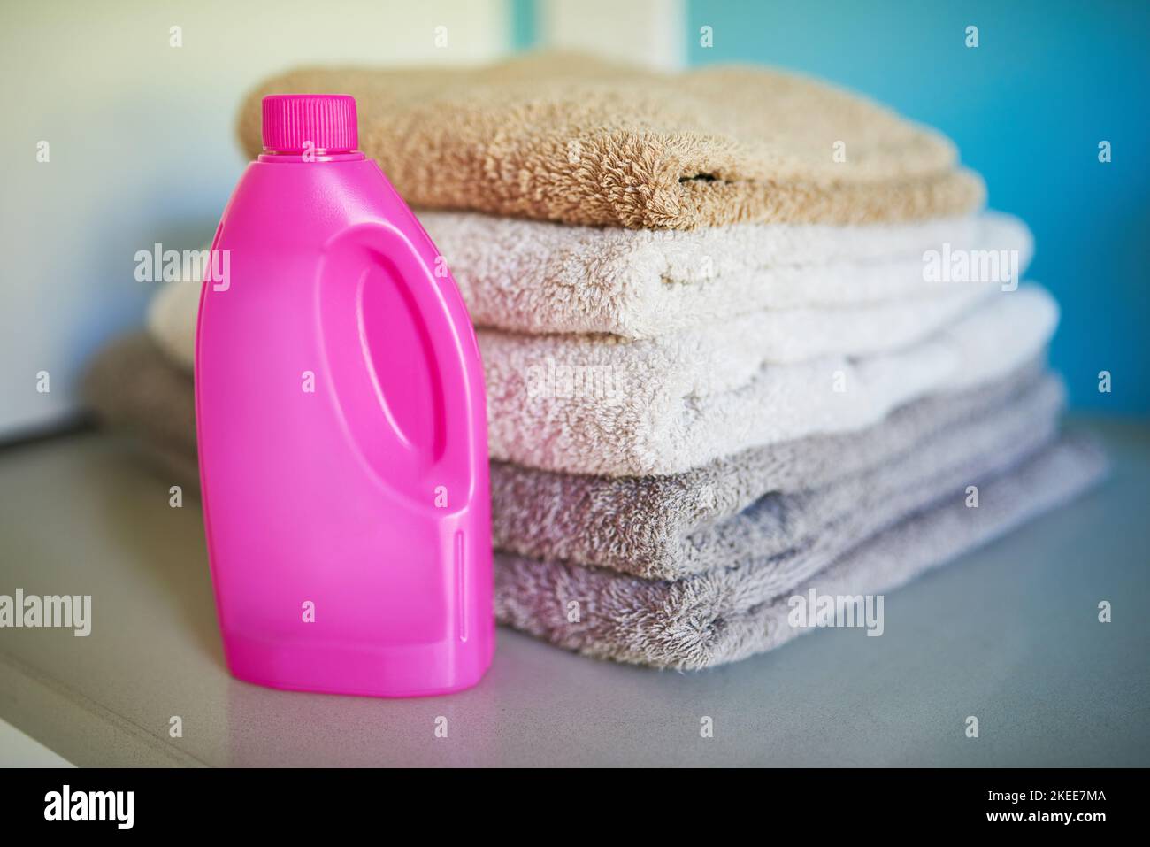 Clean and fresh. a bottle of detergent alongside a pile of folded towels Stock Photo Alamy