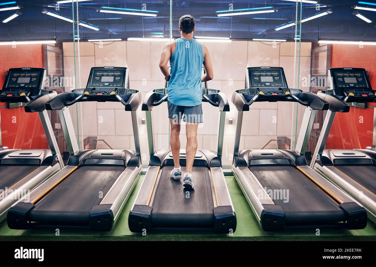 Fitness, man and running on treadmill at the gym for healthy cardio, exercise or weight loss workout. Active sports male runner training or exercising Stock Photo