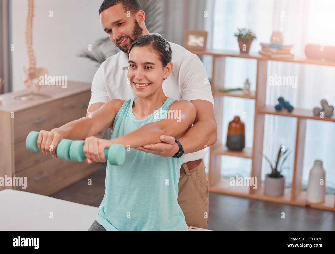 Physiotherapy, exercise and dumbbells with a man therapist and woman ...