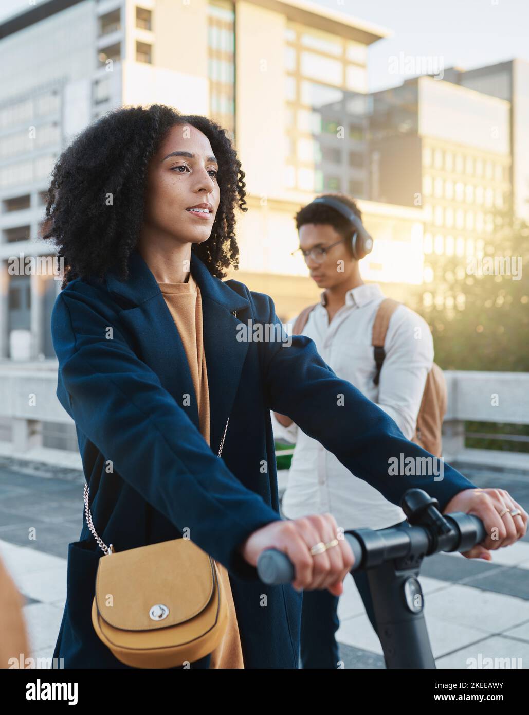 City, electric scooter and commute with a business black woman riding transport on her way to work. Travel, eco friendly and carbon footprint with a Stock Photo